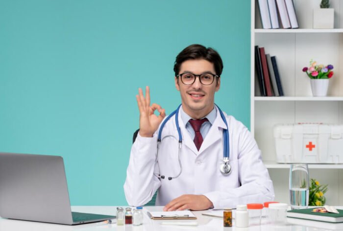 Medical smart young doctor in lab coat working remotely on computer